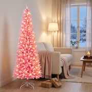 Lit pink pencil Christmas tree in the corner of a Scandinavian living room