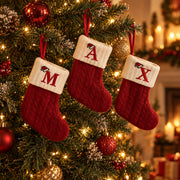 Initial stockings M, A and X hanging on a Christmas tree