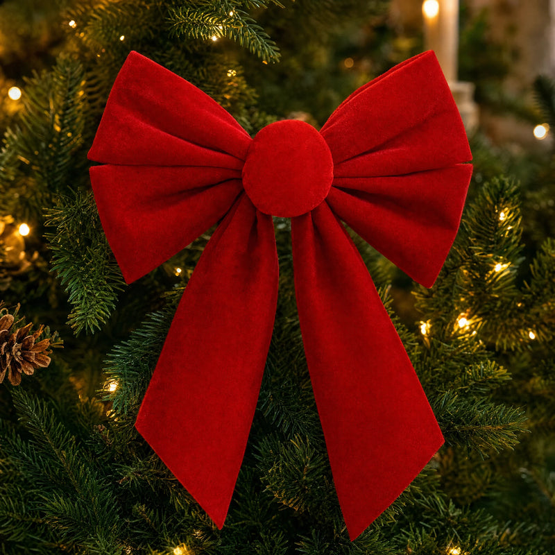 Close-up of the round knot and velvet loops of a red Christmas bow