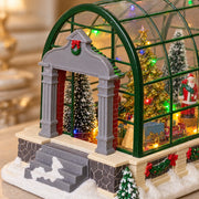 Close detail of the gray entrance portico and green greenhouse frame