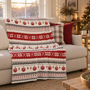 Fair isle Christmas throw over a linen sofa under a window in golden afternoon light