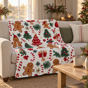 Gingerbread print Christmas throw over a linen sofa under a window in golden afternoon light
