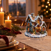 Flat acrylic Christmas snowhouse decoration on a dining table with candles and fir branches