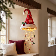 Snowflake Santa hat hanging light beside a cream and burgundy window seat.