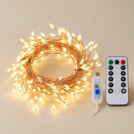 Copper wire light string coiled on a warm off-white surface with its remote control