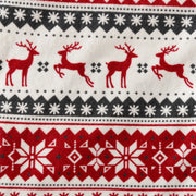 Close-up of the fair isle print showing red reindeer and snowflake bands on printed fleece