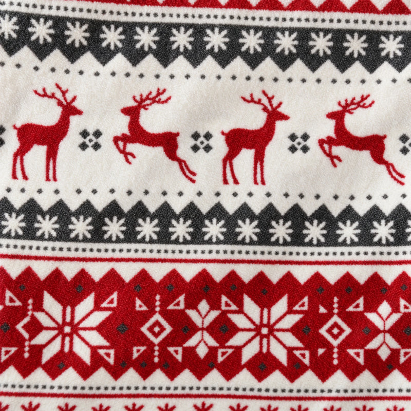 Close-up of the fair isle print showing red reindeer and snowflake bands on printed fleece