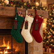 Green, cream and red knit stockings on a fireplace mantel