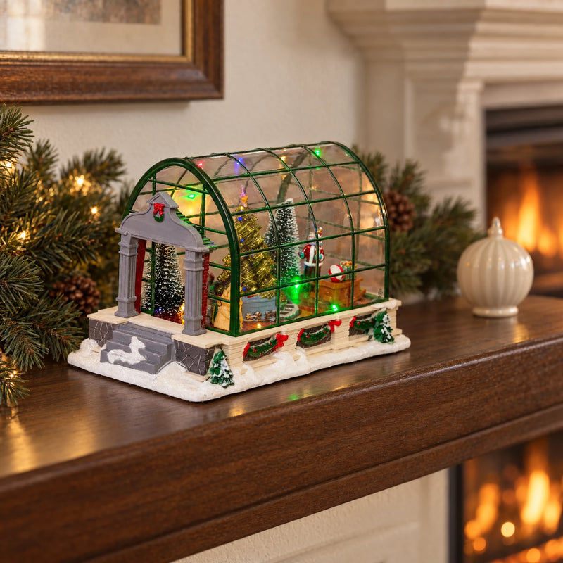 Christmas greenhouse miniature on a walnut mantel with natural fir branches