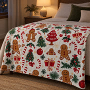 Gingerbread print Christmas throw at the foot of a bed in a bedroom lit by a warm bedside lamp