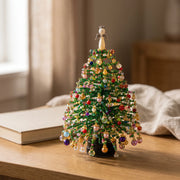 Colorful beaded holiday tree displayed in a warm home