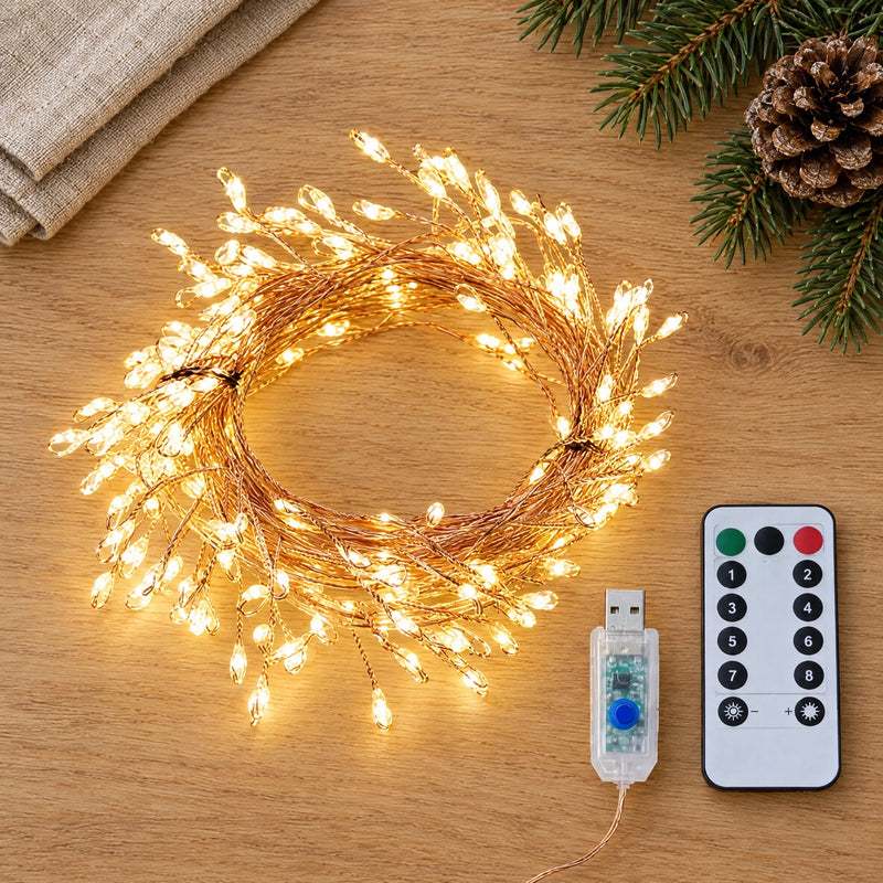 Copper wire light string, its remote control and transparent controller laid flat on a light oak table