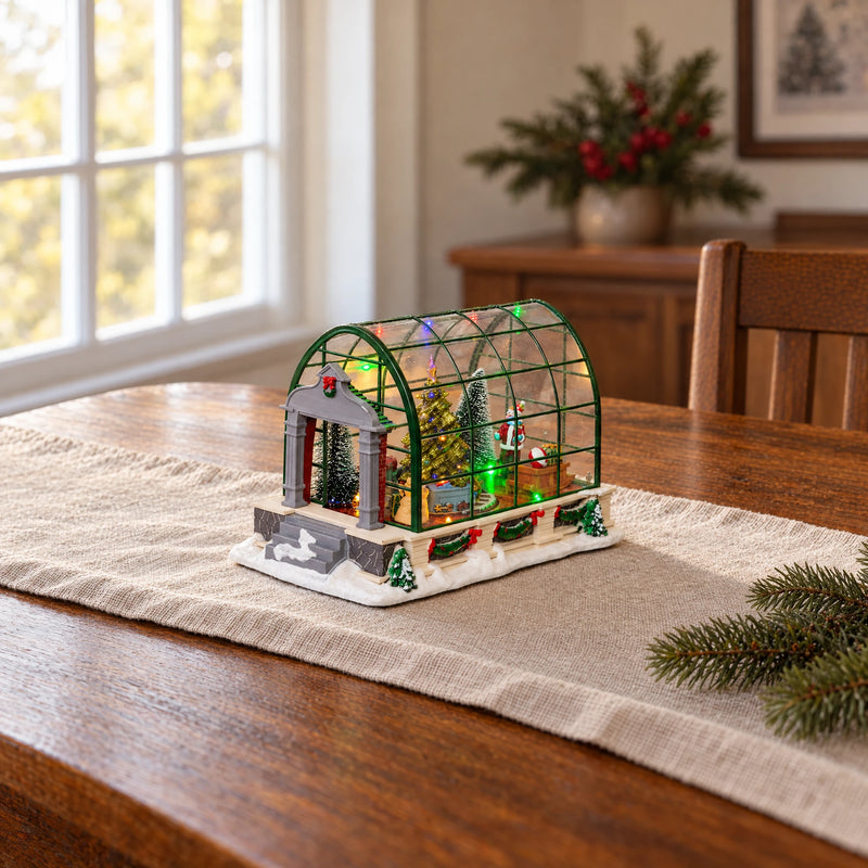 LED Christmas greenhouse on a walnut table with a cream linen runner