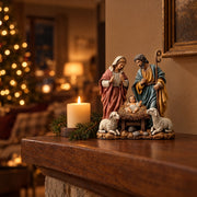 Nativity scene figurine on a wooden mantel lit by candlelight