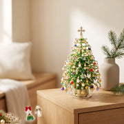 Pale beaded holiday tree with a cross-shaped top on a side table