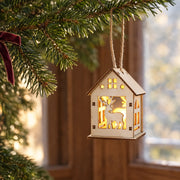 S9 reindeer Christmas house ornament hanging from a Christmas tree branch by its brown cord