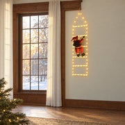 Warm White Santa Climbing Ladder Light hanging beside a wood-framed window