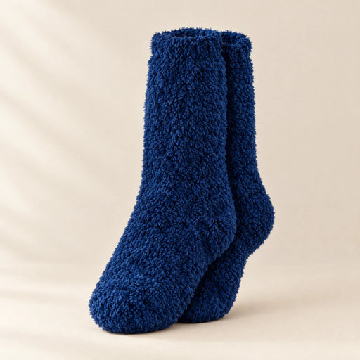 Pair of navy fleece mid-calf socks on a warm off-white studio surface