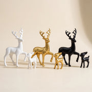 White golden and black deer and fawn figurine pairs